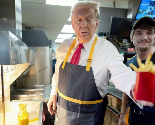 Donald J. Trump wearing an apron while dispensing french fries at a McDonald's fast food restaurant in Pennsylvania as part of a campaign stunt on Sunday, October 20, 2024. Photo by Doug Mills/AP.