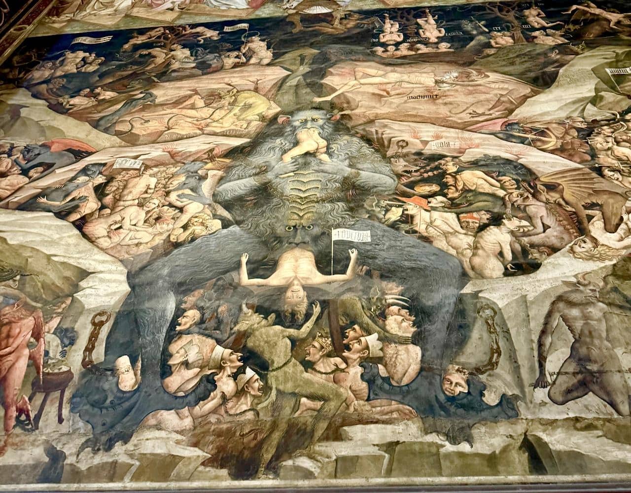 Last judgment by da Modea, Cathedral Bologna, IT. Shows tortured bodies and giant beast in the center eating the damned and shitting them out